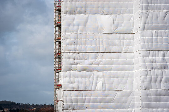 Flame retardant scaffold sheeting wrapped apartments building during insulation in england uk
