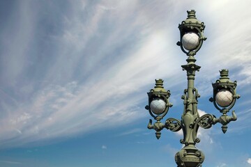 Vintage street lamp on a bridge in St. Petersburg against the sky.