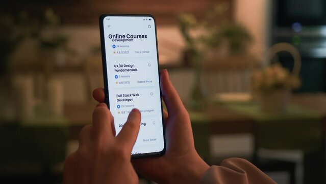 Learning to code online. Checking full stack web development online course using app for mobile phone.