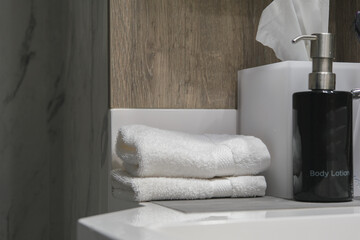 Modern design bathroom with sink, shower, towels and mirror and mosaic tiles in cabin or stateroom...