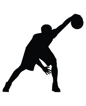 Silhouette of a basketball player who stand with the ball in hs hand and performs a crossover jab