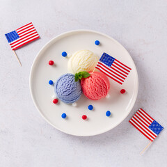 Patriotic colors ice cream scoops with American flag on white plate