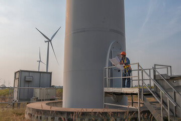 engineers are discussing maintenance of wind turbines. Clean energy. Alternative energy concept.  