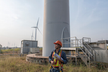engineers are discussing maintenance of wind turbines. Clean energy. Alternative energy concept.  