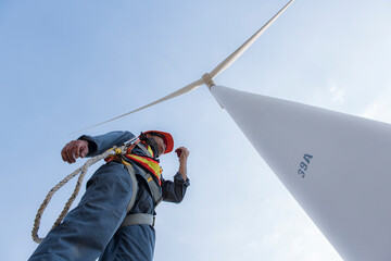 engineers are discussing maintenance of wind turbines. Clean energy. Alternative energy concept.  ...