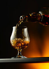 Cognac or brandy being poured into a glass.