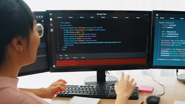 Slow motion back end software developer engineer for computer programming working together on debugging writing computing code, solving complex algorithms display on monitor in office. Burgeoning