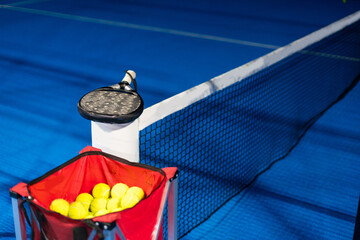 Paddle ball on racket. Yellow paddle ball laying near racket, 