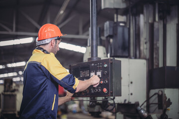 Technician adjusts and troubleshoots factory machinery for optimal performance and safety standard