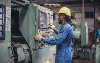 Technician adjusts and troubleshoots factory machinery for optimal performance and safety standard