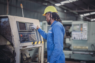 Technician adjusts and troubleshoots factory machinery for optimal performance and safety standard