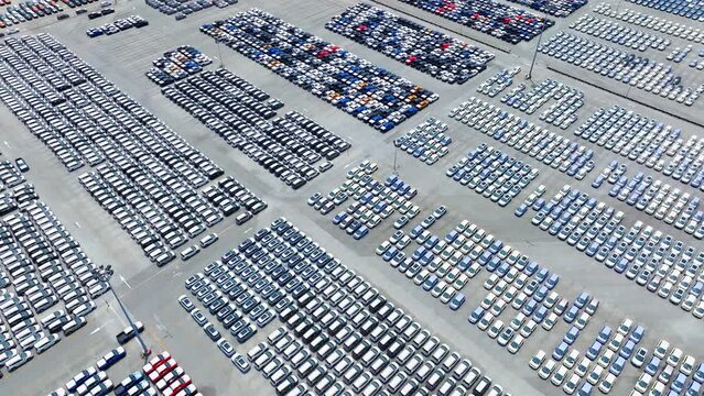 The parking lot unfolds like a meticulously crafted mosaic, with cars neatly arranged in perfect formation. It's a testament to the seamless integration of technology in modern transportation.
