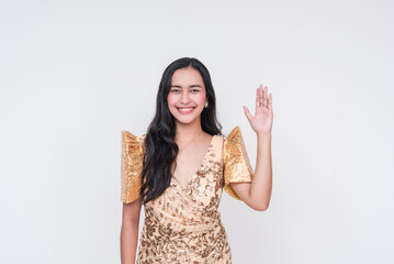 Filipino woman in traditional Filipiniana dress, raising hand on white background