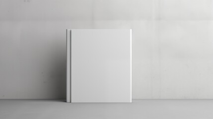 A Blank White Book Standing Against a Neutral Backdrop