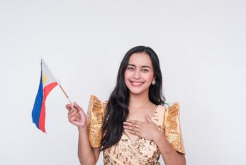 Filipino woman in traditional Filipiniana dress holding Philippine flag on white background