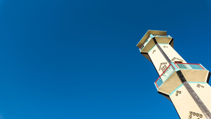 Low angle photo of Indonesian mosque minaret with clear blue sky backgrounds. Empty blank copy text space - Powered by Adobe