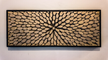 A room wall decoration made from many pieces of wood and arranged in one large frame.