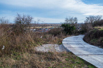 Concrete panel road in nature. Autumn, sunny weather.