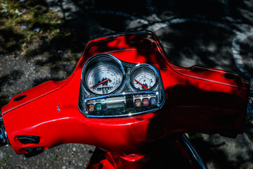 Close-Up of Red Scooter Dashboard in Sunlight in Italy