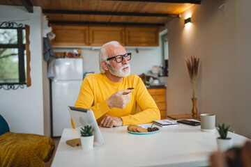 Senior caucasian Man Enjoy Breakfast at Home with Jam and Biscuit