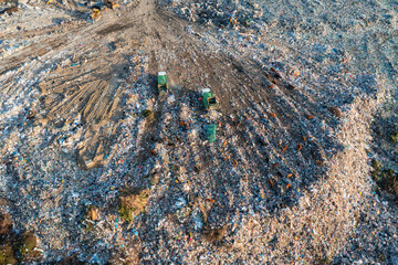 Rubbish dump. Aerial view of garbage pile in trash dump. Dump track unload waste at landfill. Biohazard for ecosystem and healthy environment concept. Environmental pollution. View from drone