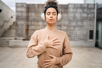 woman caucasian female using headphones for online guided meditation