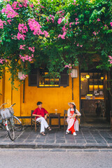 Asian Couple wearing vietnam  traditional culture  walking around at Hoi An ancient town,Hoi an...