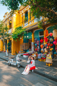 Asian woman wearing vietnam  traditional culture  walking around at Hoi An ancient town,Hoi an city in Vietnam.