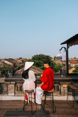Asian Couple wearing vietnam  traditional culture  walking around at Hoi An ancient town,Hoi an city in Vietnam.