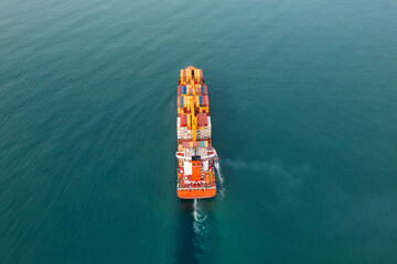 Aerial back view of cargo ship carrying containers for import and export, business logistic and transportation in open sea. Drone view. Freight shipping - 790735500