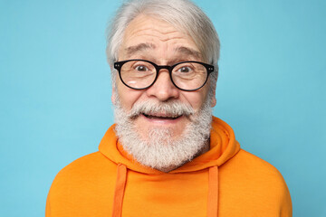 Senior man with mustache on light blue background