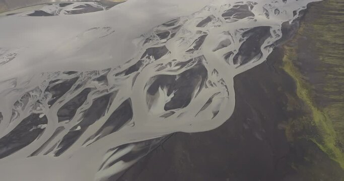 Aerial Panning Shot Of Natural Pattern Of Braided River Flowing On Landscape - Unknown, Iceland