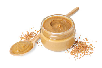 Fresh tasty mustard sauce in jar, spoon and dry seeds isolated on white