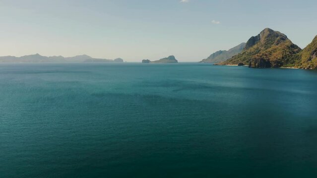 Aerial view bay with lagoon and turquoise water on a tropical island against the backdrop of the mountains. Corong corong beach, El Nido, Palawan, Philippines. Summer and travel vacation concept