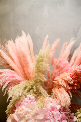 Close-up of sprigs of artificial pink fern, pink hydrangea and other decorative sprigs