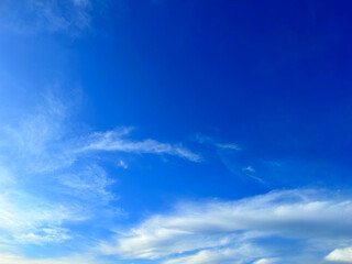 Blue with white background. Aesthetic neutral photo of the sky with small clouds, in sunny weather.
