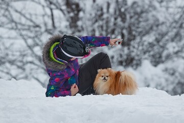 Playing with small dog in the snow
