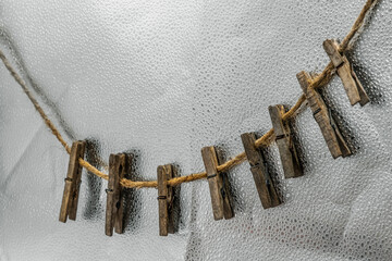Old wooden clothespins, laundry hooks, on hemp rope