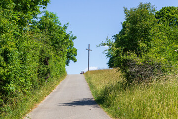 Footpath to observation point with summit cross and bench at hill Walberla in Franconian Switzerland, Germany