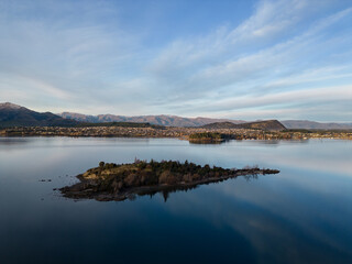 Wanaka, New Zealand: Aerial drone view of the Ruby island in Lake Wanaka in lake afternoon in New Zealand south island.