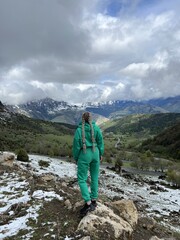 A woman on the background of the Ceylomsky pass in Ingushetia. A trip uphill to the Tsei Lum pass...