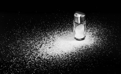 Scattered salt and a standing salt shaker