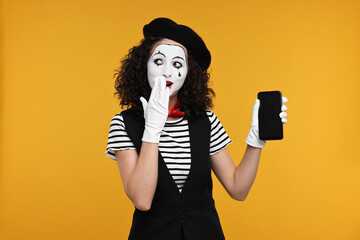 Funny mine with phone posing on orange background