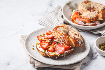 Bagel with cream cheese, strawberries and pistachio for breakfast.