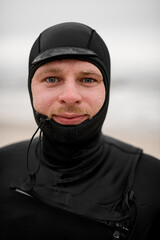 Close-up photo of a male surfer's face showing water droplets