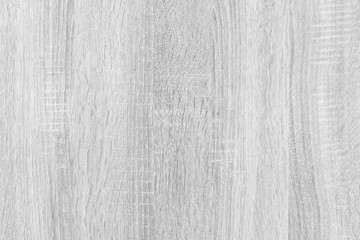 A wooden surface with a grainy texture. The surface is white and has a rough, uneven appearance