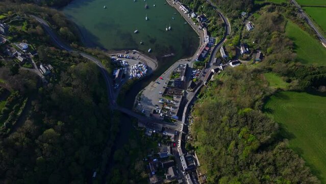 Aerial shot flying over and revealing coastal fishing village of Fishguard, Wales