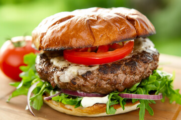 big tasty hamburger or burger with grilled beef and salad, unhealthy fat fast or junk food