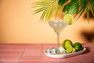 Margarita, alcoholic cocktail with lime, silver tequila, ice cubes and salt. Pink tropical background. - 790807543