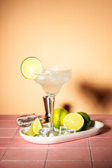 Margarita, alcoholic cocktail with lime, silver tequila, ice cubes and salt. Pink tropical background. - 790807729
